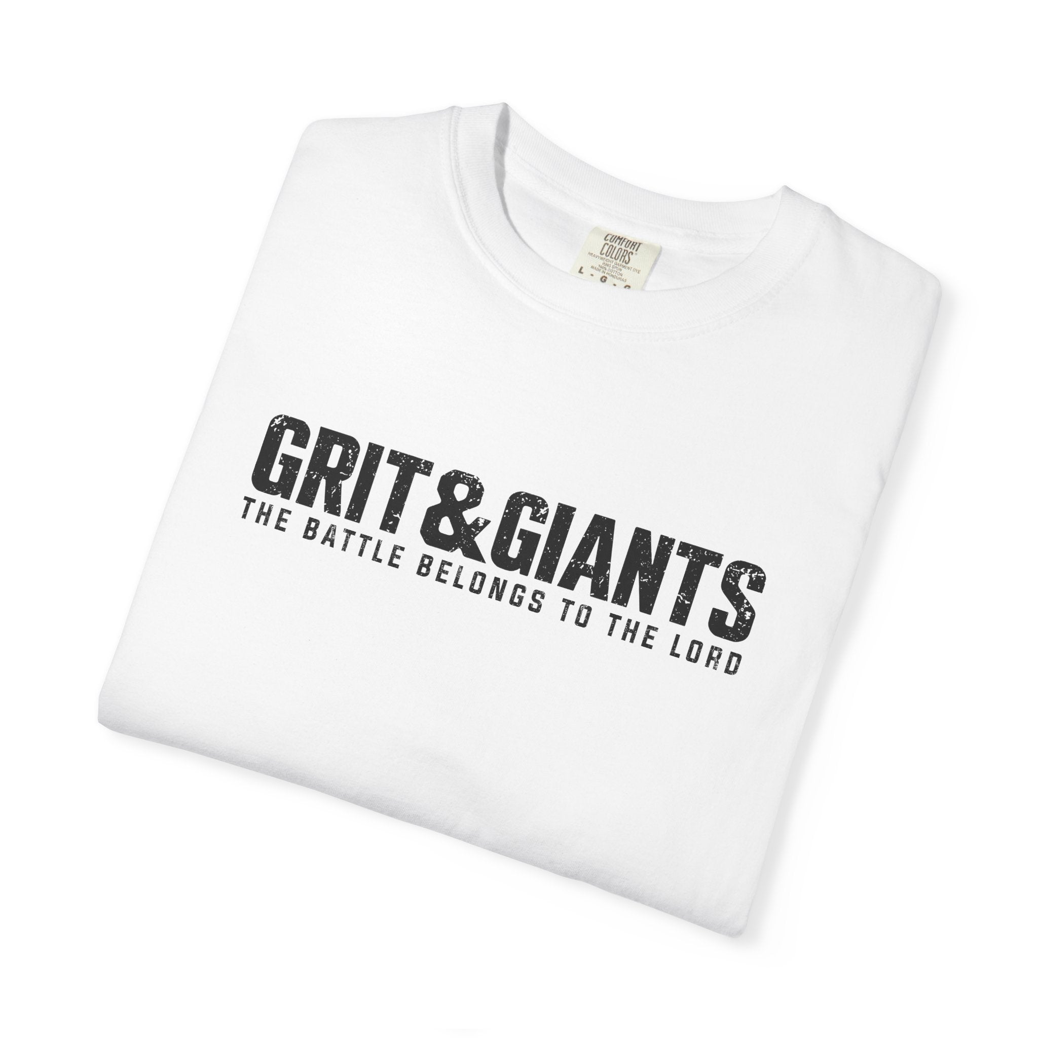 Folded white Grit & Giants Battle Tee featuring The Battle Belongs to the Lord graphic.