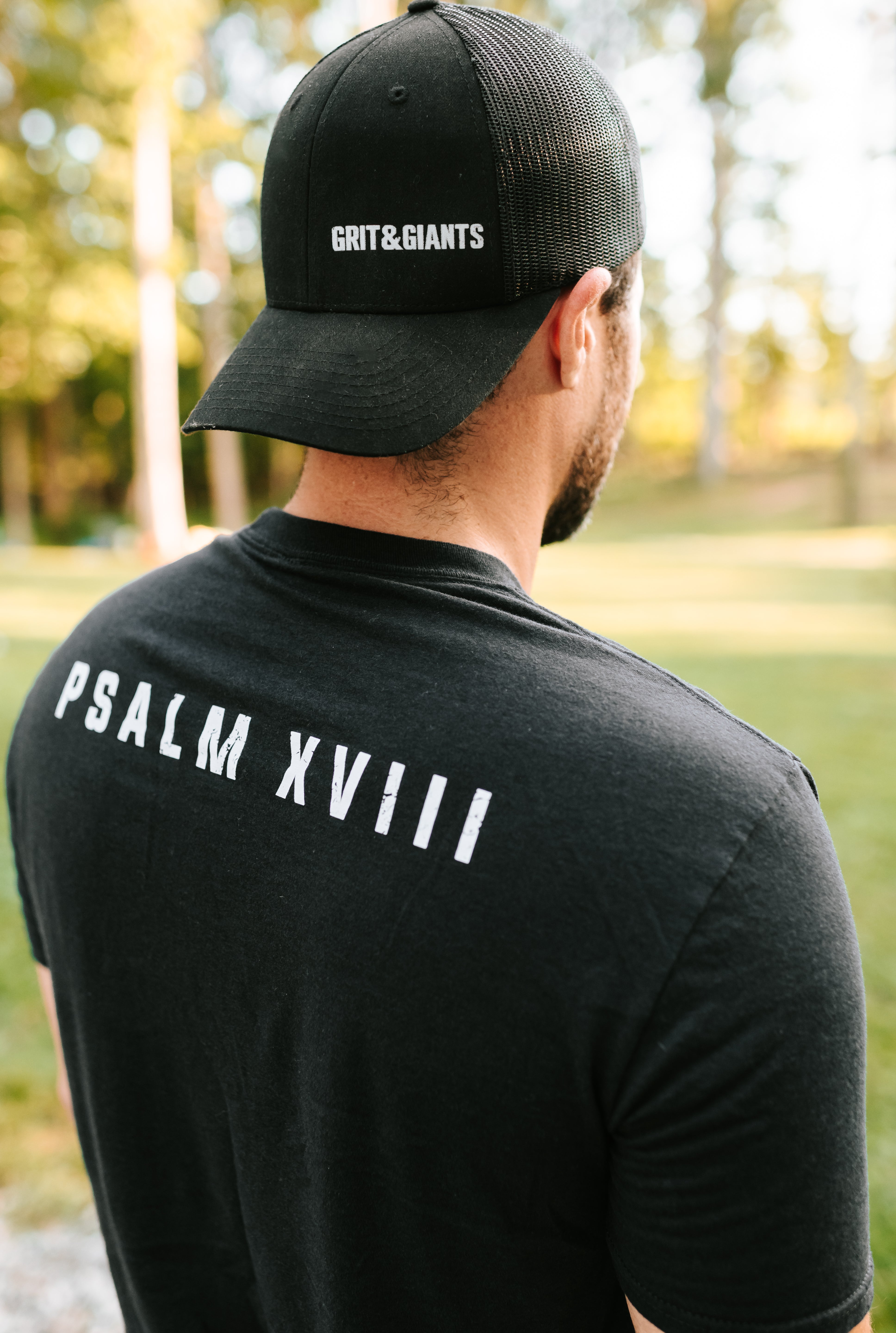 Back of black Grit & Giants Refuge Training Tee featuring Psalm XVIII.